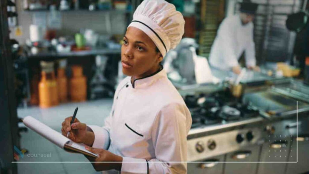 An image of a chef browsing his laptop/brainstorming/taking notes